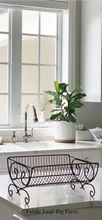 Load image into Gallery viewer, A starter fiddle-leaf fig in the background of a kitchen, sitting in a window in a ceramic pot.
