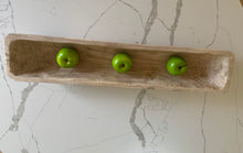 Load image into Gallery viewer, A wooden trug filled with three green apples on a marble countertop.
