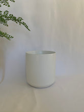 Load image into Gallery viewer, A matte white ceramic pot in front of a white background.
