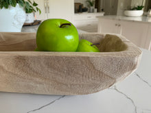 Load image into Gallery viewer, A close-up of a wooden trug filled with green apples on a marble countertop.
